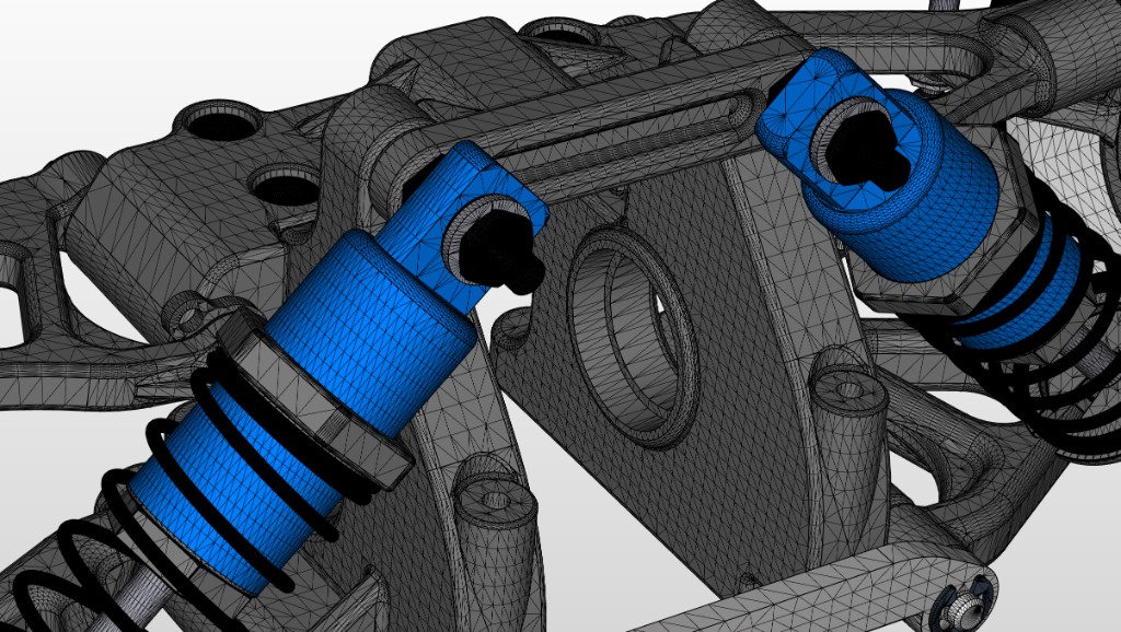 Close-up of a vehicle suspension. The shock absorbers are shown as a blue mesh so density can be inspected, with the surrounding parts shown as a gray mesh.